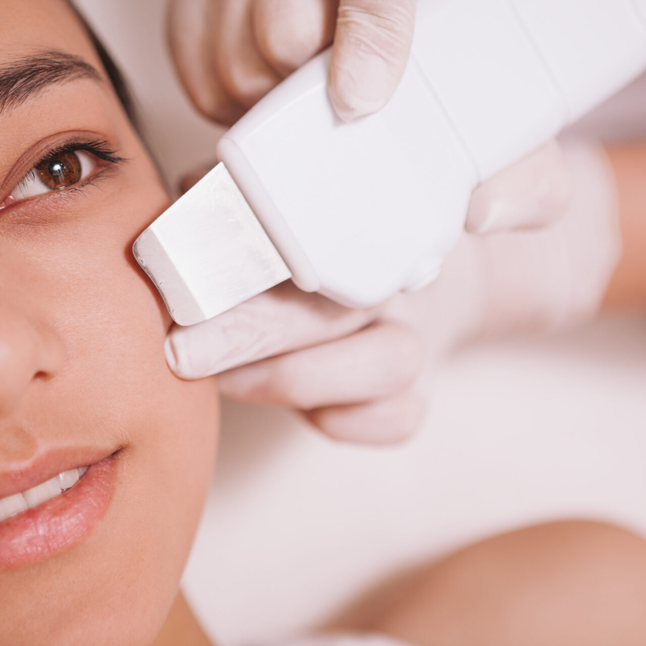 Close up of a yung Asian woman getting ultrasonic cavitation cleaning procedure at beauty salon